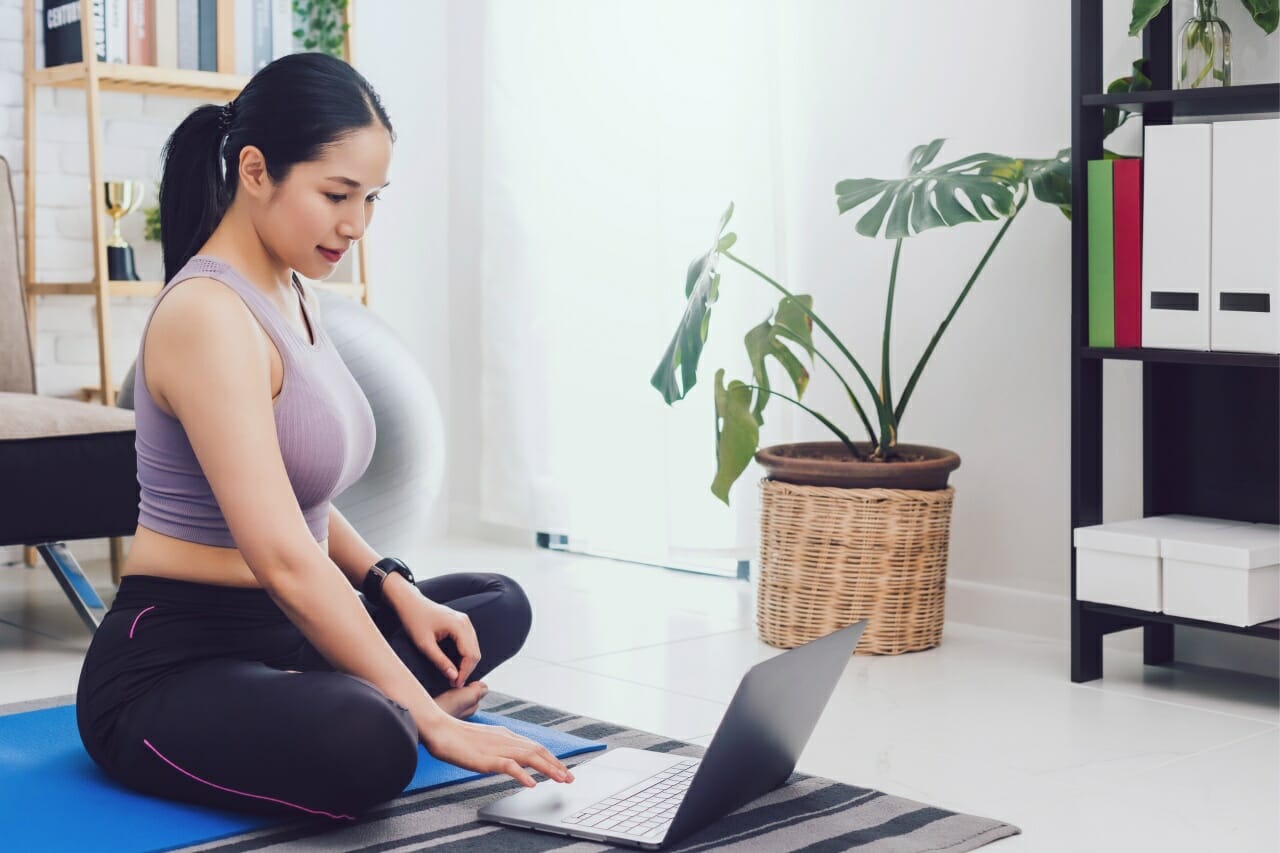 asian-beautiful-woman-exercise-at-home-and-watching-training-video-on-laptop